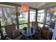 Bright sun room with all glass windows features seating and decor at 5888 17Th W St # C23, Bradenton, FL 34207