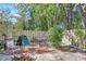 Outdoor patio with a table and chairs, surrounded by a fence and lush greenery at 6414 Sun Eagle Ln, Bradenton, FL 34210
