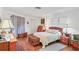 Comfortable bedroom with hardwood floors, decorative accents, and ample natural light creating a peaceful retreat at 6414 Sun Eagle Ln, Bradenton, FL 34210