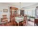 Elegant dining room featuring hardwood floors, a china cabinet, and natural light from a large window at 6414 Sun Eagle Ln, Bradenton, FL 34210