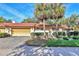 Inviting home featuring a red tile roof, two-car garage, and mature landscaping with palm trees at 6414 Sun Eagle Ln, Bradenton, FL 34210