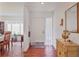 Bright foyer featuring hardwood floors, a decorative mirror, and an adjacent dining area at 6414 Sun Eagle Ln, Bradenton, FL 34210