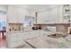 Well-lit kitchen boasts ample countertop space, white cabinetry, and a functional layout for cooking at 6414 Sun Eagle Ln, Bradenton, FL 34210