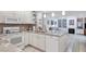 Open kitchen features a breakfast bar, white appliances, and seamless connection to the living area at 6414 Sun Eagle Ln, Bradenton, FL 34210
