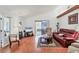 Inviting living room featuring hardwood floors, a vaulted ceiling, and a sliding glass door to the patio at 6414 Sun Eagle Ln, Bradenton, FL 34210