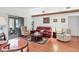 Comfortable living room featuring hardwood floors, ample seating, and a bright, airy atmosphere at 6414 Sun Eagle Ln, Bradenton, FL 34210