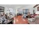 Expansive living room boasts hardwood floors, comfortable seating, and glass doors to the outdoors at 6414 Sun Eagle Ln, Bradenton, FL 34210