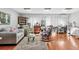 Spacious living room filled with natural light, featuring hardwood floors, cozy seating, and ample display shelves at 6414 Sun Eagle Ln, Bradenton, FL 34210