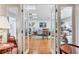 Inviting living room entrance framed by glass doors, showcasing hardwood floors and comfortable seating arrangement at 6414 Sun Eagle Ln, Bradenton, FL 34210