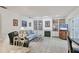 Cozy living room with built-in shelving, a fireplace, and comfortable seating, adjoining to the kitchen at 6414 Sun Eagle Ln, Bradenton, FL 34210