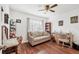 Cozy living room with a comfortable couch, desk, bookshelf, and wood-look laminate flooring at 6414 Sun Eagle Ln, Bradenton, FL 34210