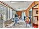 Sunroom with a variety of furniture and decor, wooden walls, and multiple windows for natural light at 6414 Sun Eagle Ln, Bradenton, FL 34210