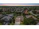 Beautiful aerial view of a neighborhood with lush landscaping and serene water features at sunset at 6532 Coopers Hawk Ct, Lakewood Ranch, FL 34202
