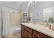 Well-lit bathroom featuring a shower-tub combo and dark wood vanity at 6532 Coopers Hawk Ct, Lakewood Ranch, FL 34202