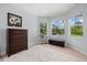 Bright bedroom featuring a dark wood dresser, neutral carpet and lots of windows at 6532 Coopers Hawk Ct, Lakewood Ranch, FL 34202