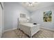 Cozy bedroom featuring a white bed frame and an area rug at 6532 Coopers Hawk Ct, Lakewood Ranch, FL 34202