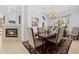 Elegant dining room with a fireplace, chandelier, and a beautifully set table for formal dinners at 6532 Coopers Hawk Ct, Lakewood Ranch, FL 34202