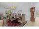 Charming dining room with a classic grandfather clock, chandelier, and formal dining set at 6532 Coopers Hawk Ct, Lakewood Ranch, FL 34202