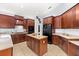 Spacious kitchen features a center island, granite countertops and rich wood cabinets at 6532 Coopers Hawk Ct, Lakewood Ranch, FL 34202