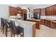 Entertainer's kitchen with island, bar, and generous countertop space at 6532 Coopers Hawk Ct, Lakewood Ranch, FL 34202