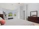Bedroom featuring a dark wood dresser, a ceiling fan and many windows at 6532 Coopers Hawk Ct, Lakewood Ranch, FL 34202