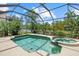 The sparkling swimming pool and spa is surrounded by screened enclosure at 6532 Coopers Hawk Ct, Lakewood Ranch, FL 34202
