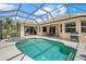Backyard pool and spa has screened enclosure, a patio, and landscaping at 6532 Coopers Hawk Ct, Lakewood Ranch, FL 34202