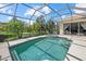 Backyard pool and spa features a screened enclosure, a patio and landscaping at 6532 Coopers Hawk Ct, Lakewood Ranch, FL 34202