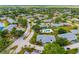Aerial view of a home in a lush community with mature trees and manicured landscaping near a pool at 6940 W Country Club N Dr # V-77, Sarasota, FL 34243