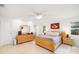 Bright bedroom with natural light, tiled floor and white ceiling fan at 6940 W Country Club N Dr # V-77, Sarasota, FL 34243