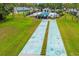 Aerial view of shuffleboard courts on lush lawn surrounded by pool and neighborhood amenities at 6940 W Country Club N Dr # V-77, Sarasota, FL 34243
