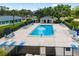 Sparkling community pool with lounge seating and lush landscaping for relaxation at 6940 W Country Club N Dr # V-77, Sarasota, FL 34243