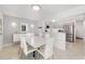Bright dining room featuring a modern white dining set, accent lighting and tile floors at 6940 W Country Club N Dr # V-77, Sarasota, FL 34243