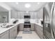Updated kitchen with stainless steel appliances, grey cabinetry, and ample counter space at 6940 W Country Club N Dr # V-77, Sarasota, FL 34243