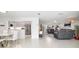Bright open concept living and dining area with tile floors leading into an updated kitchen with stainless steel appliances at 6940 W Country Club N Dr # V-77, Sarasota, FL 34243