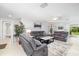 Spacious living room featuring tile floors, a ceiling fan, and comfortable modern sofas at 6940 W Country Club N Dr # V-77, Sarasota, FL 34243