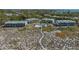 Aerial view of beachfront property with a pool, surrounded by lush greenery and residences at 6951 Gulf Of Mexico Dr # 14, Longboat Key, FL 34228