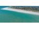 Breathtaking aerial view of oceanfront homes and a sandy beach along a vibrant gulf coast at 6951 Gulf Of Mexico Dr # 14, Longboat Key, FL 34228
