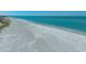 Panoramic aerial view of a serene sandy beach along a beautiful gulf coast shoreline at 6951 Gulf Of Mexico Dr # 14, Longboat Key, FL 34228