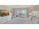 Bright main bedroom with sliding glass doors leading to outdoor patio with ocean view at 6951 Gulf Of Mexico Dr # 14, Longboat Key, FL 34228