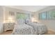 Bright bedroom with two twin beds and beach-themed decor at 6951 Gulf Of Mexico Dr # 14, Longboat Key, FL 34228