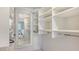 Large walk-in closet with custom shelving and full-length mirror at 6951 Gulf Of Mexico Dr # 14, Longboat Key, FL 34228