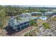 Exterior shot of a condo complex with a pool, lush greenery, and beach access at 6951 Gulf Of Mexico Dr # 14, Longboat Key, FL 34228