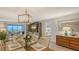 Open-concept dining area with seating and views to the living area and Primary bedroom at 6951 Gulf Of Mexico Dr # 14, Longboat Key, FL 34228
