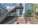 Charming condo exterior showing unit's entryway with stairway and updated neutral paint at 6951 Gulf Of Mexico Dr # 14, Longboat Key, FL 34228