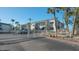 Gated community entrance with lush landscaping and building exteriors visible from the road at 6951 Gulf Of Mexico Dr # 14, Longboat Key, FL 34228