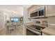 Updated kitchen appliances including a stainless steel microwave and glass cooktop range at 6951 Gulf Of Mexico Dr # 14, Longboat Key, FL 34228