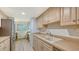 Functional kitchen with stainless appliances, wood cabinets, laminate counters, and a view to office space at 6951 Gulf Of Mexico Dr # 14, Longboat Key, FL 34228