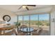 Relaxing sunroom with seating, views of beach, and ceiling fan at 6951 Gulf Of Mexico Dr # 14, Longboat Key, FL 34228