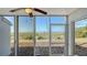 Screened lanai with ceiling fan provides panoramic views of landscaped grounds and the ocean at 6951 Gulf Of Mexico Dr # 14, Longboat Key, FL 34228